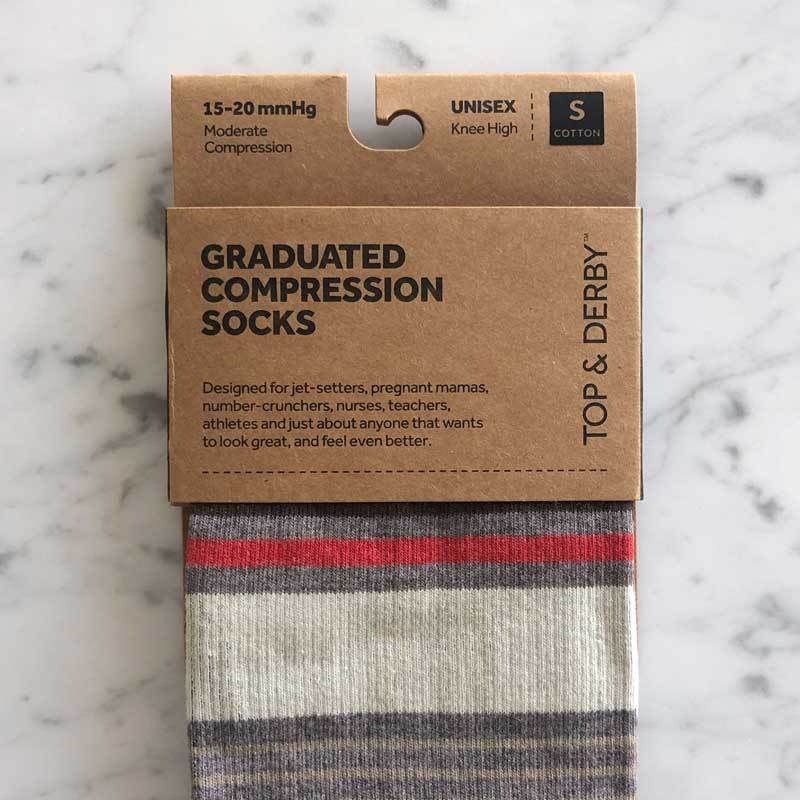 Stripe pattern prescription compression socks in brown, cream and red in packaging