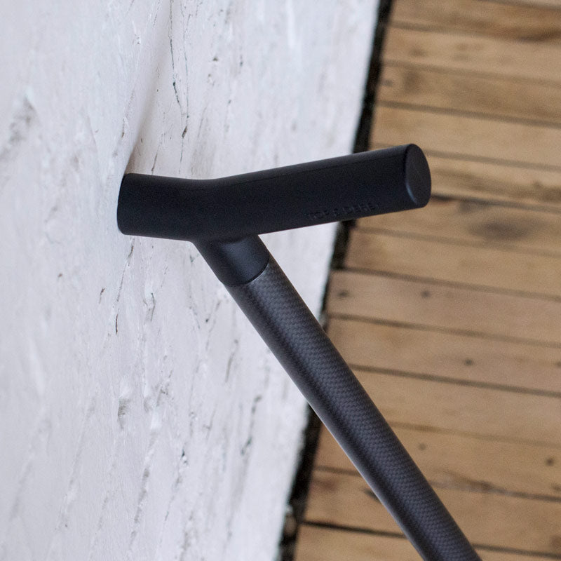 Black CFX designer Top & Derby walking stick leaning on brick wall